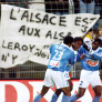 Strasbourg's Guy Mancamba Luyindula (C) is congratulated by team-mates Habib Beye (L) and Pierre Njanka Beaka (R) after scoring his team's 1st goal on December 03, 1999 against Bastia